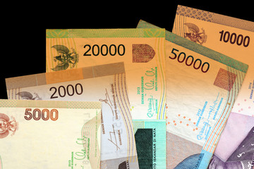 Several Indonesian rupiah close up. Money background brown color toned