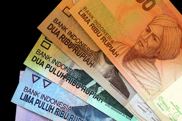 Several Indonesian rupiah close up. Money background brown color toned