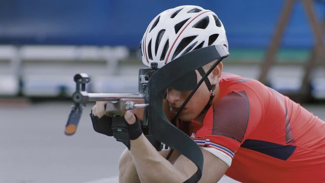 Portrait of Caucasian male professional biathlete practicing on a shooting range during mid-season practice in summer. ARRI Alexa Mini with Cooke S4 prime lenses RAW graded footage