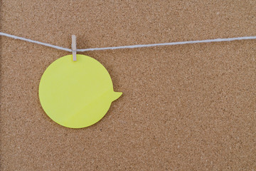 Corkboard with yellow sticker fixed by a pin. Round shaped sheets stuck on a billboard by colored...