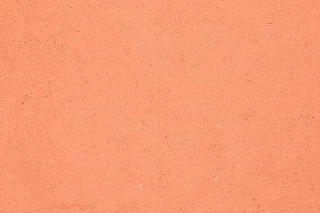 Light orange colored low contrast Concrete textured background with roughness and irregularities to your concept or product.