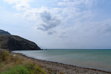 Black Sea coast on a cloudy day with clouds in the sky. .