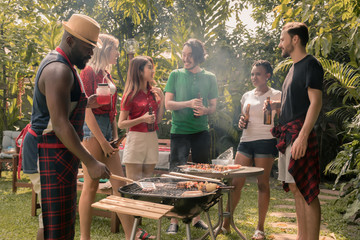 barbecue and party.Happy friends with barbecue party in nature