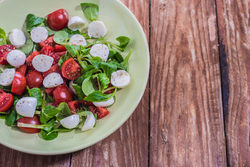 Fresh delicious tomatoes. With mozzarella cheese typical italian healthy cuisine culture.. Red tomatoes on a wood background.