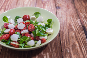 Fresh delicious tomatoes. With mozzarella cheese typical italian healthy cuisine culture.. Red tomatoes on a wood background.