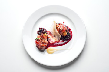  Chicken wrapped in bacon on a white plate