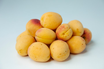 Ripe apricots fruit on a white surface