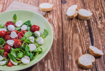 Fresh delicious tomatoes. With mozzarella cheese typical italian healthy cuisine culture.. Red tomatoes on a wood background.
