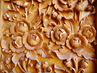 Pattern of flower carved on wood background.