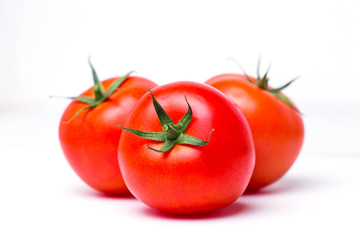 Three ripe red tomatoes on white isolate background, closeup