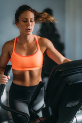 Woman Exercising on Elliptical Cross Trainer