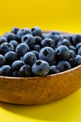 Fresh blueberry in wooden bowl