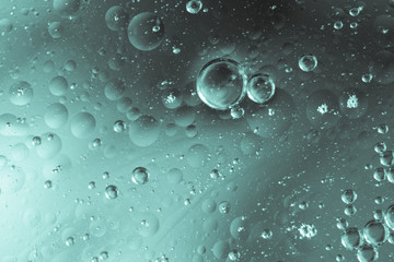 Oily bubbles in water with drops