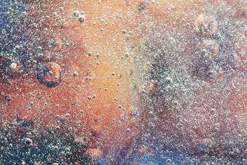 Air bubbles splash in water on colorful background