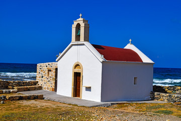 Fototapeta na wymiar Small church by the sea in Chersonissos on the Crete, Greece.