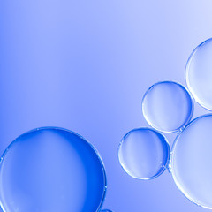 Abstract clear air bubbles in water on defocused background