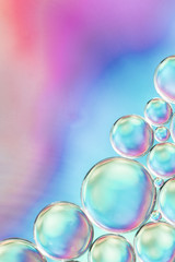 Abstract colorful air bubbles in water on saturated blurred background