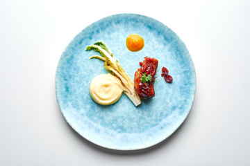  meat dish with puree and pak-choy cabbage on plate