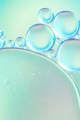 Abstract air bubbles and oil drops in water on multicolored defocused background
