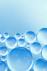 Abstract air bubbles in liquid on cyan defocused background
