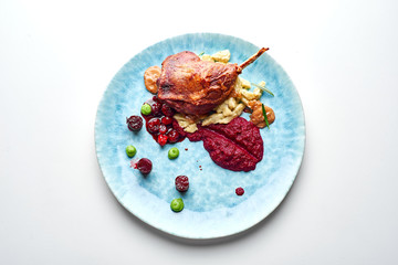 Confit goose leg crisp delicious served with garnish