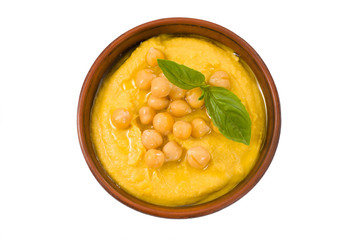 Hummus in a bowl isolated on white top view