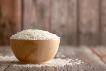 Rice in a brown bowl on the wooden table