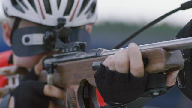 Portrait of Caucasian male professional biathlete practicing on a shooting range during mid-season practice in summer. ARRI Alexa Mini with Cooke S4 prime lenses RAW graded footage