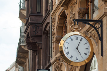 Fototapeta na wymiar closeup of vintage clock in the street