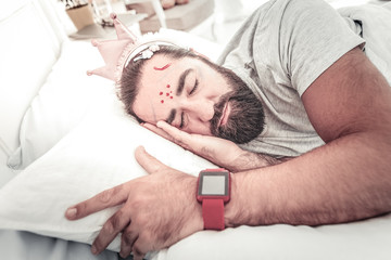 Sleeping man with painted face by his kids