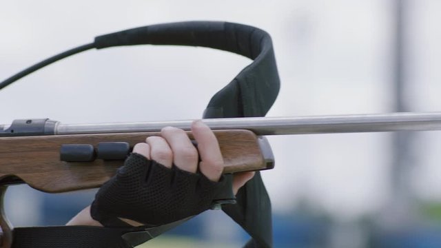 Portrait of Caucasian male professional biathlete practicing on a shooting range during mid-season practice in summer. ARRI Alexa Mini with Cooke S4 prime lenses RAW graded footage