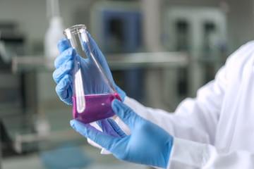 Scientist holding the flask in the laboratory	