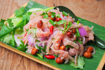 Thai traditional food fermented ground pork, fresh red and green chilli on fresh whole banana leaf
