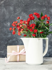 Present or gift box in a craft paper with gold ribbon bow