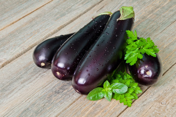 Fresh ripe eggplants on a wooden table