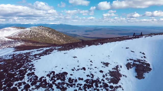 People hiking in snowed mountain top. Pineda de la Sierra, Burgos. Spain.