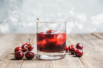 Old fashioned cherry cocktail with berries. Selective focus. Shallow depth of field. 