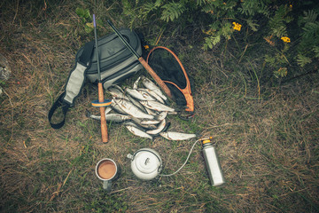 Fishing tackle on the river. Snack on a fishing trip.