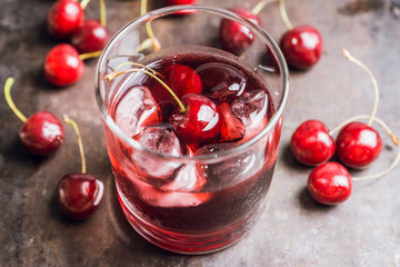 Old fashioned cherry cocktail with berries. Selective focus. Shallow depth of field. 