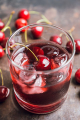 Old fashioned cherry cocktail with berries. Selective focus. Shallow depth of field. 