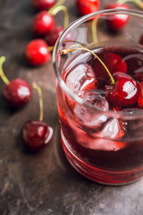 Old fashioned cherry cocktail with berries. Selective focus. Shallow depth of field. 
