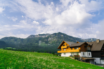 Morning in the Alps. Beautiful foggy morning scenery in Alps region, Austria. Great morning view of foggy mountains, fog, house and green meadow in Austria
