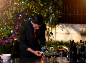 High ISO.The bartender with a cocktail is preparing a cocktail at the bar. Alcoholic beverages, people and luxury concepts.barman making cocktail at nightclub