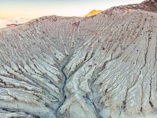 Aerial shot of the Ijen volcano or Kawah Ijen on the Indonesian language. Famous volcano containing the biggest in the world acid lake and sulfur mining spot at the place where volcanic gasses come