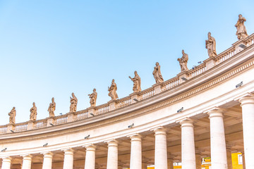 Fototapeta na wymiar Doric Colonnade with statues of saints on the top. St. Peters Square, Vatican City