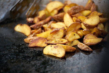 Potato wedges on black background. Top view. close up