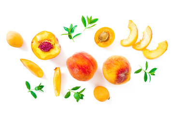 Ripe peaches and apricot with leaves isolated on white background. Fruit pattern. Top view. Flat lay