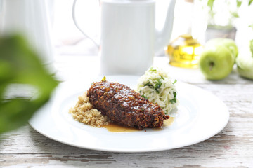 Vegetarian cuisine. An appetizing vegetable chop dish served with groats and salad.