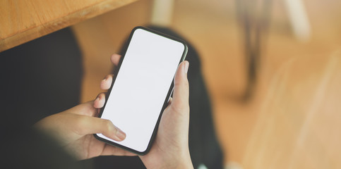 Young girl holding blank screen smartphone