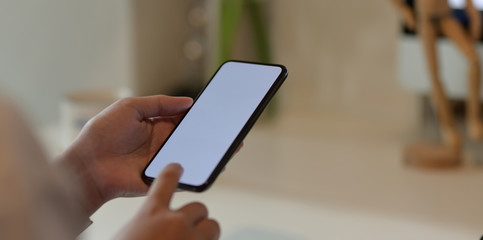 Close-up view of teenage girl touching her smartphone